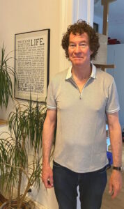 Photo of Richard Killian. Richard Killian has experience with financial systems and budget platforms including SAP Business ByDesign, Workday, PSU SIMBA, ClearGov budget software, and financial reporting dashboards. In the Photo Richard Killian is wearing a nice shirt. The photo is taken inside with a sign about living a good life in the background. 